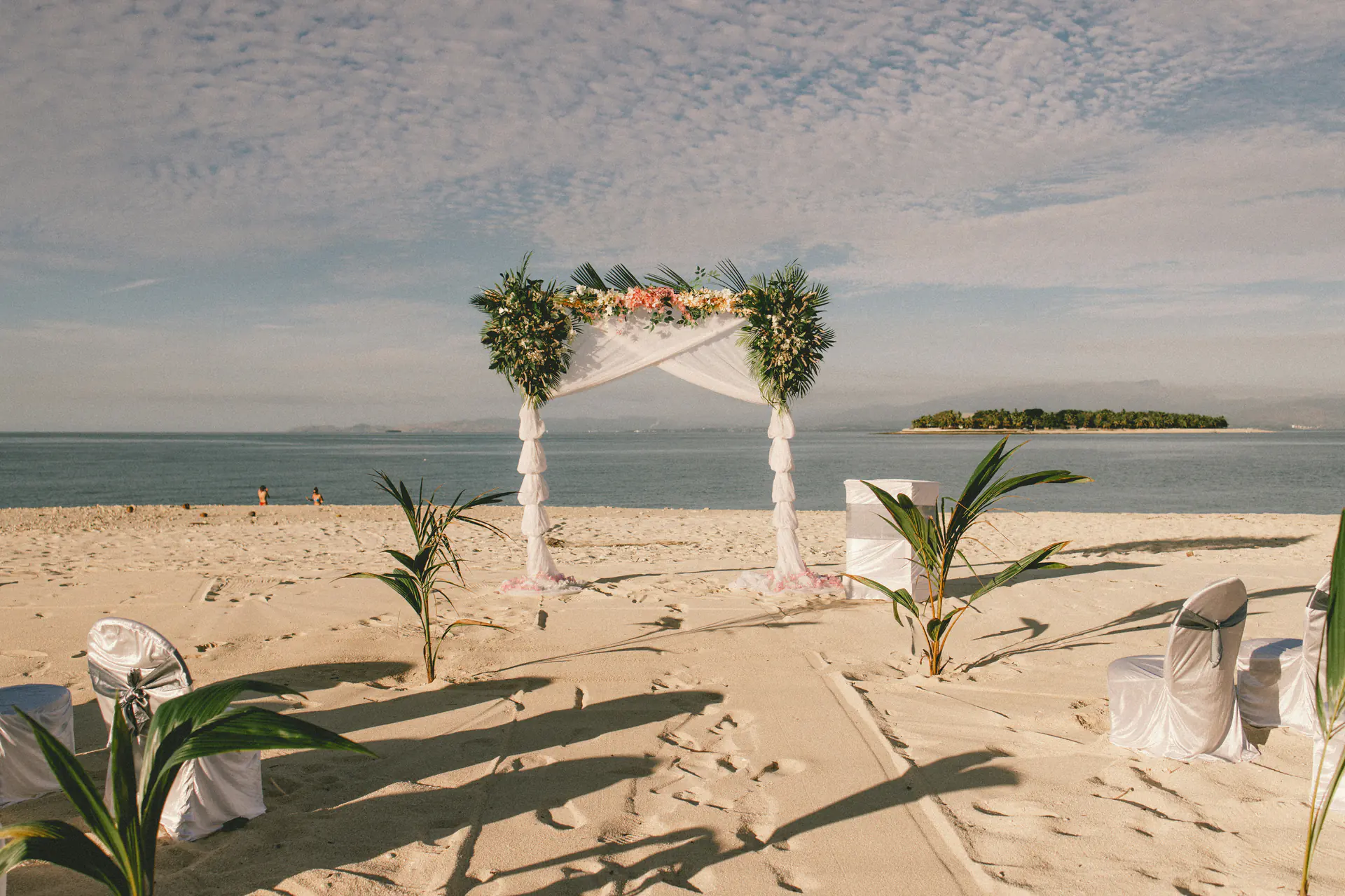 Beach wedding ceremony facing the sea